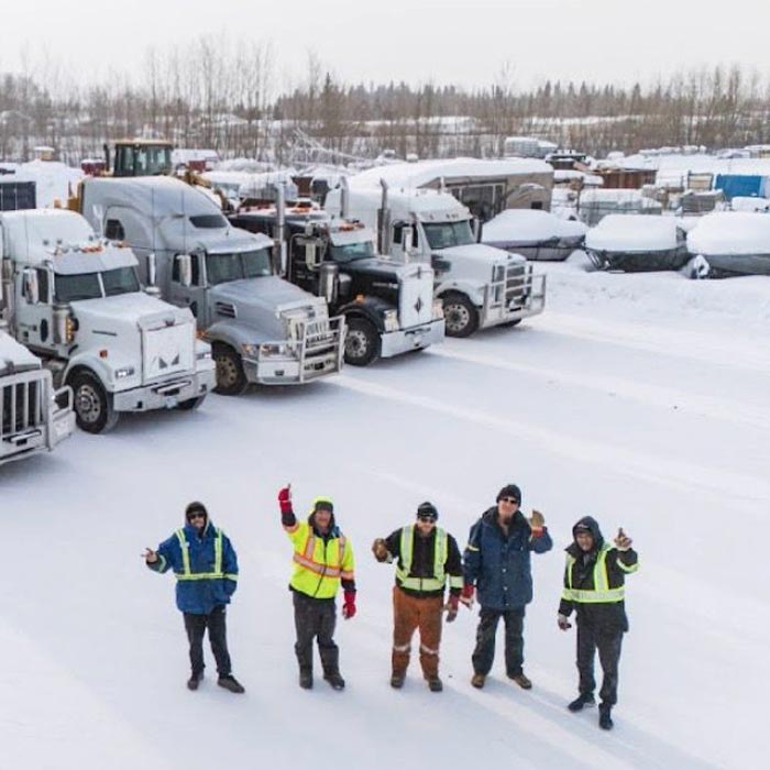RailCore X team waving in front of fleet of vehicles