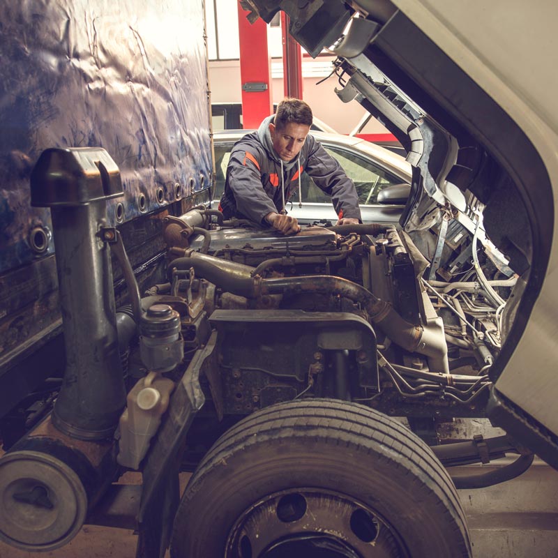 heavy duty truck mechanic working on engine